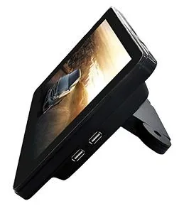 Black taxi advertising display with a landscape screen on an angled headrest bracket, seen from the side with USB ports on its edge