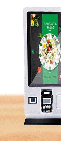 White countertop ordering kiosk with a portrait touchscreen and a front card terminal cradle between the scanner and printer, on a dark foot
