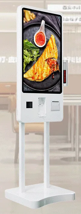 White freestanding ordering kiosk with a portrait touchscreen, scanner, card terminal and printer beneath it, on twin poles over a contoured base