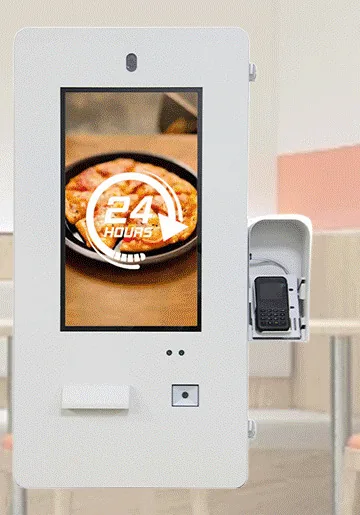 White outdoor wall-mounted payment kiosk with a portrait touchscreen, printer slot and a shrouded card terminal on the right side