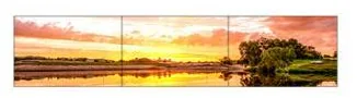 Three landscape panels joined in a single row to form a wide banner video wall showing one sunset picture